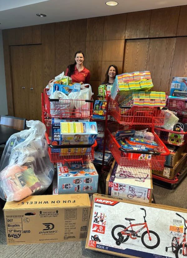 Representatives of Electrical Corporation of America presented a donation of toys and holiday supplies