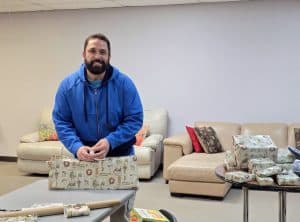 Brandon Crowley wraps gifts for his two boys Ezra and Brandon Isaiah